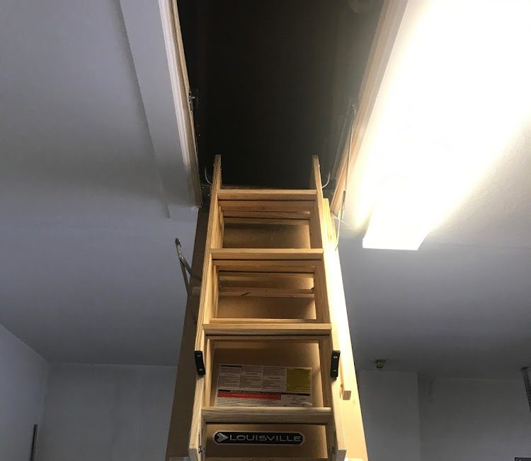 Newly installed attic ladder with secure mounting in Ocoee